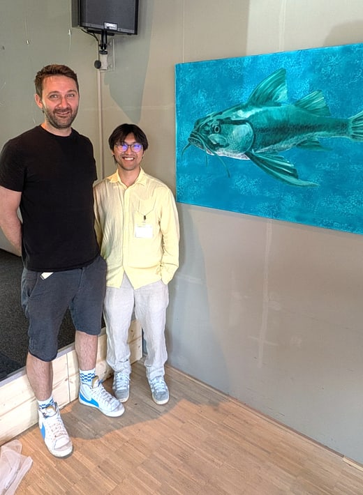 Sebastian and Garmani in front of their artwork “Touched Catfish,” which is composed of fingerprints